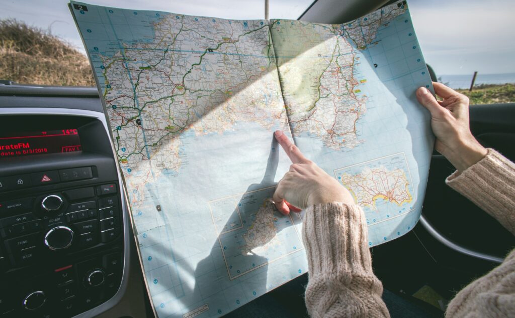 Map in car. Person getting ready for a summer road trip. 